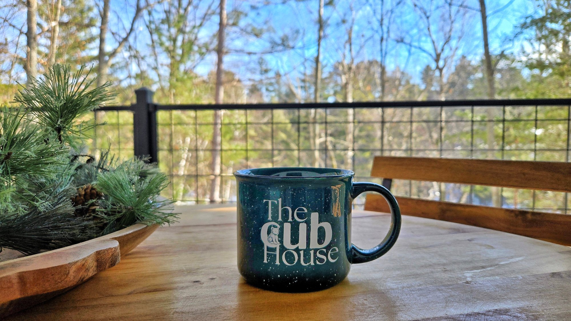 Branded mug deck bistro table river view fall