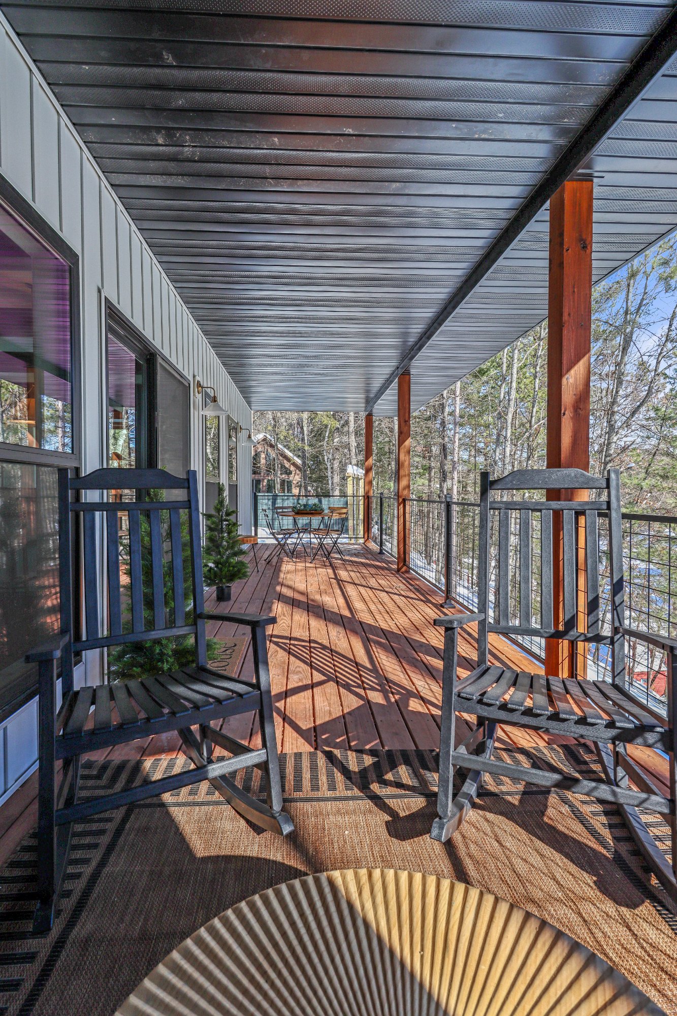 Covered deck long view rocking chairs red cedar posts