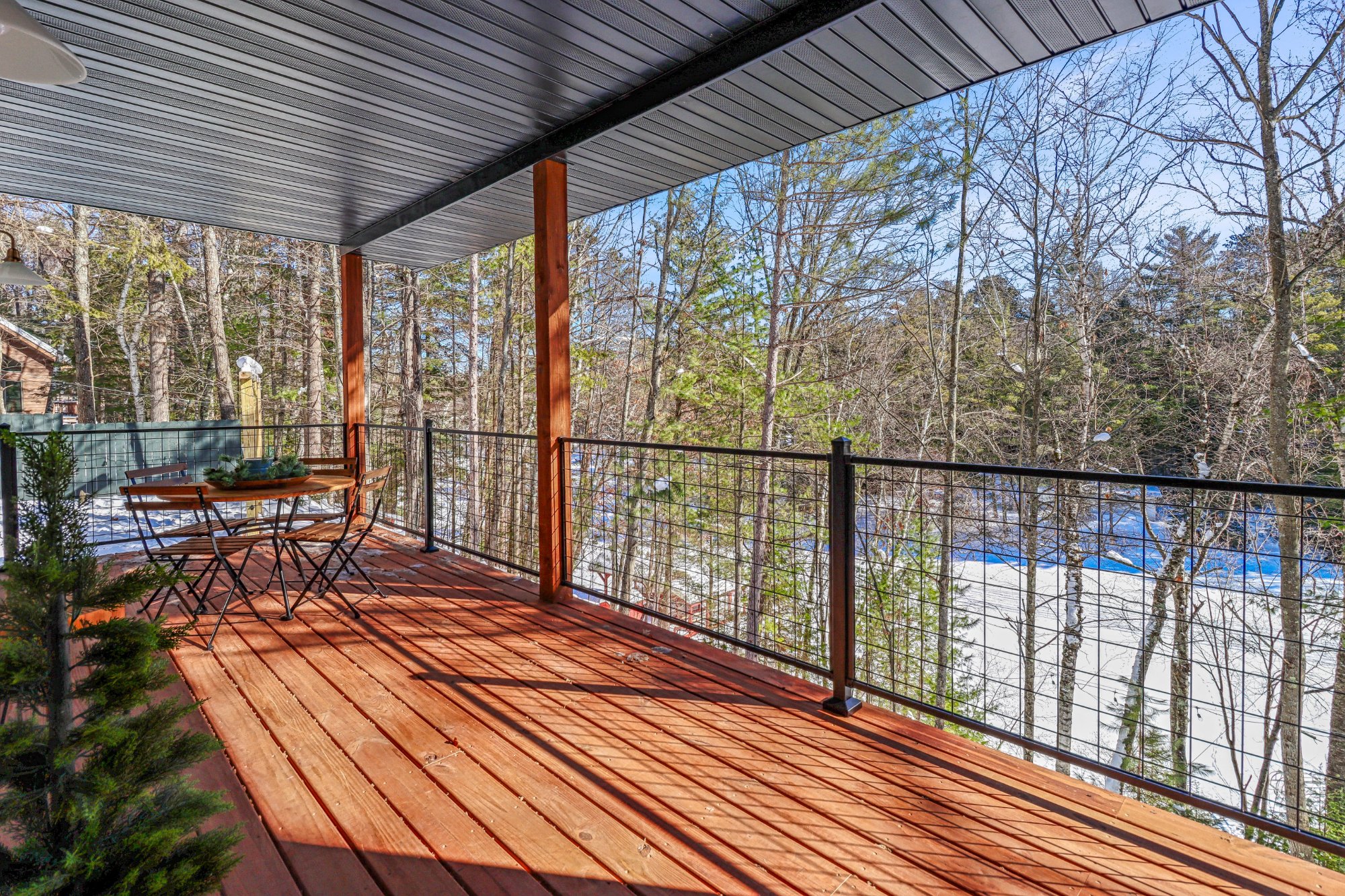 Covered deck wide red cedar cable rail winter