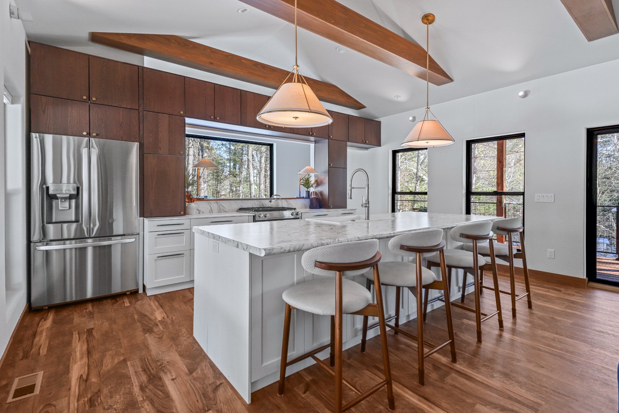 Kitchen island wide angle walnut cabinets vaulted beams