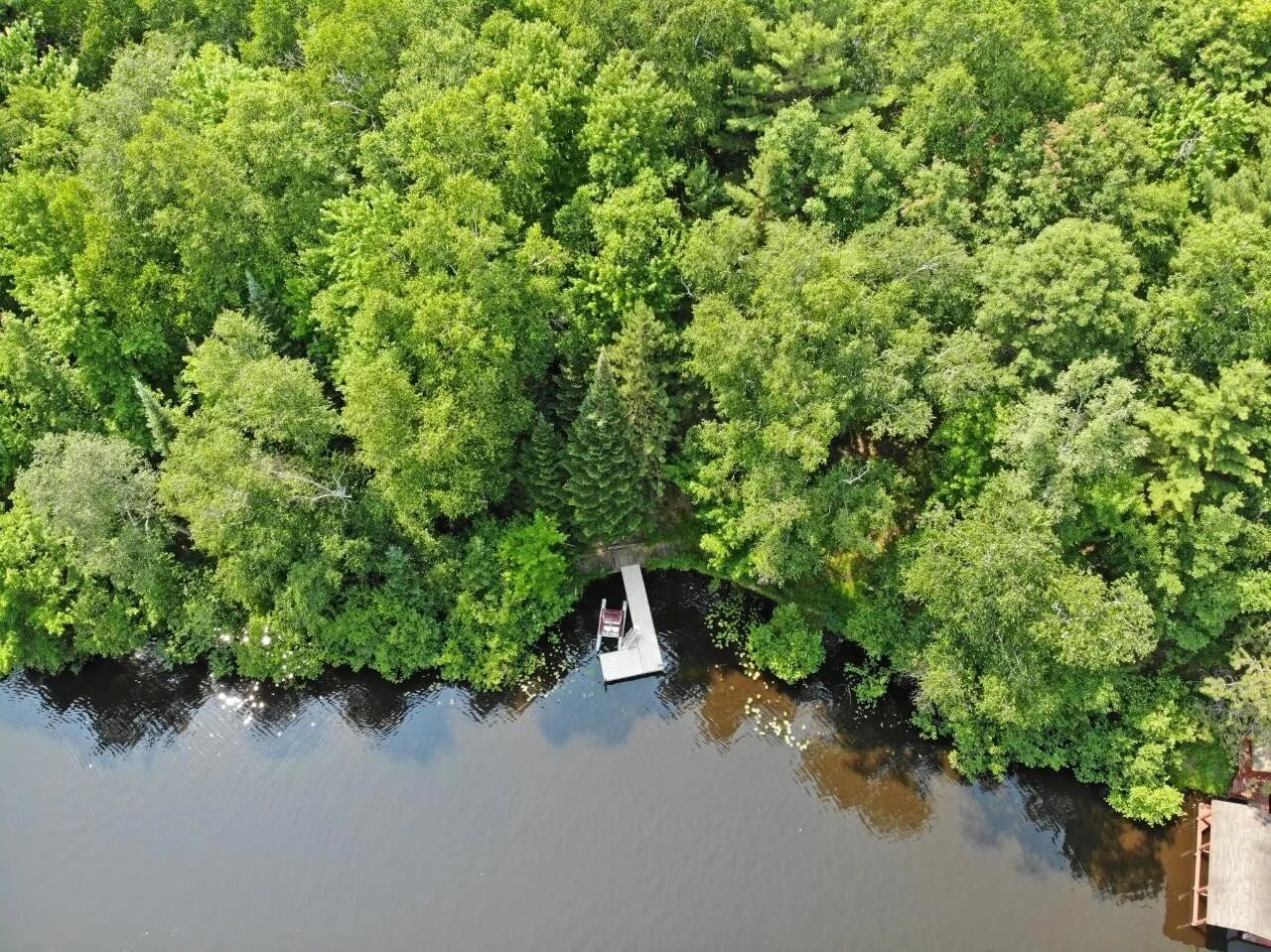 Aerial view of the property, private dock, and river