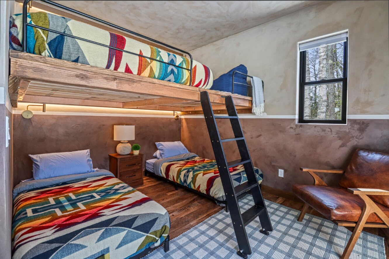 Bunk beds, ladder, and reading chair