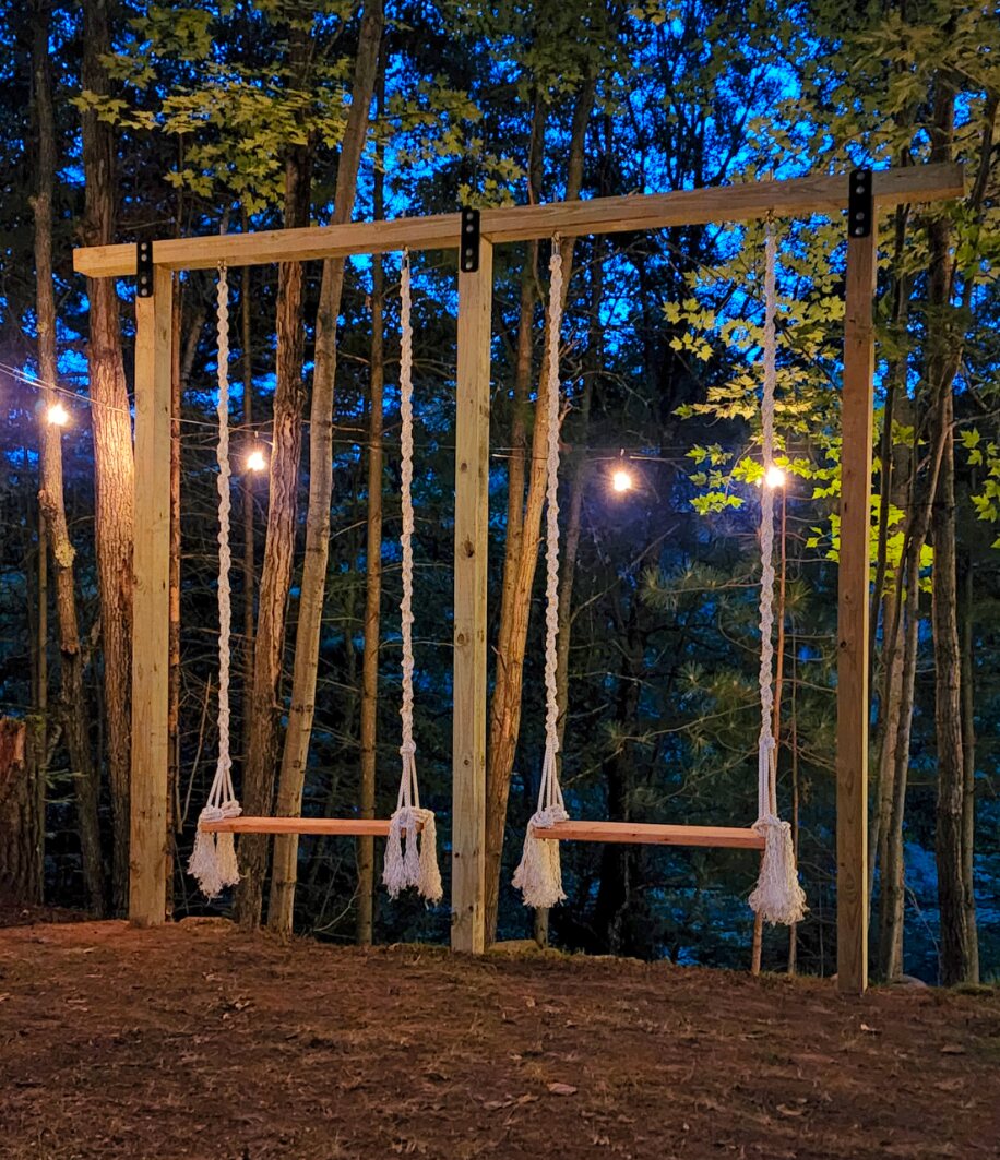 Hillside swings beneath string lights at night