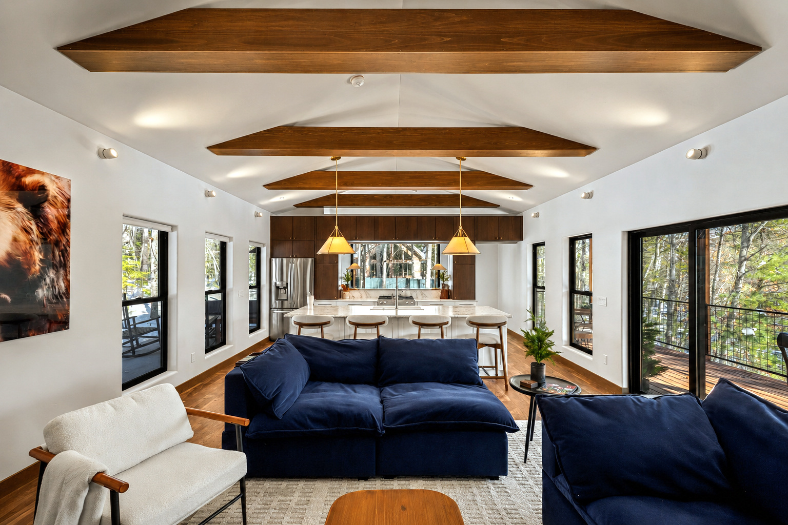 Open living room and kitchen with vaulted wood beams