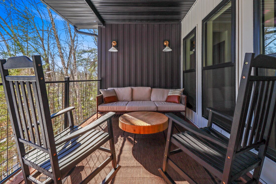 Lower covered deck with rocking chairs and outdoor sofa