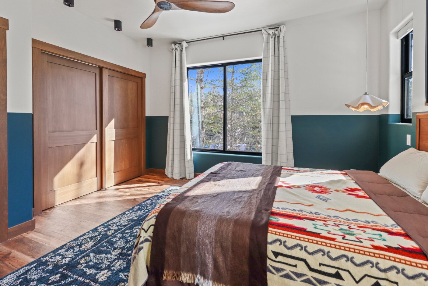 Primary bedroom window and wood closet doors