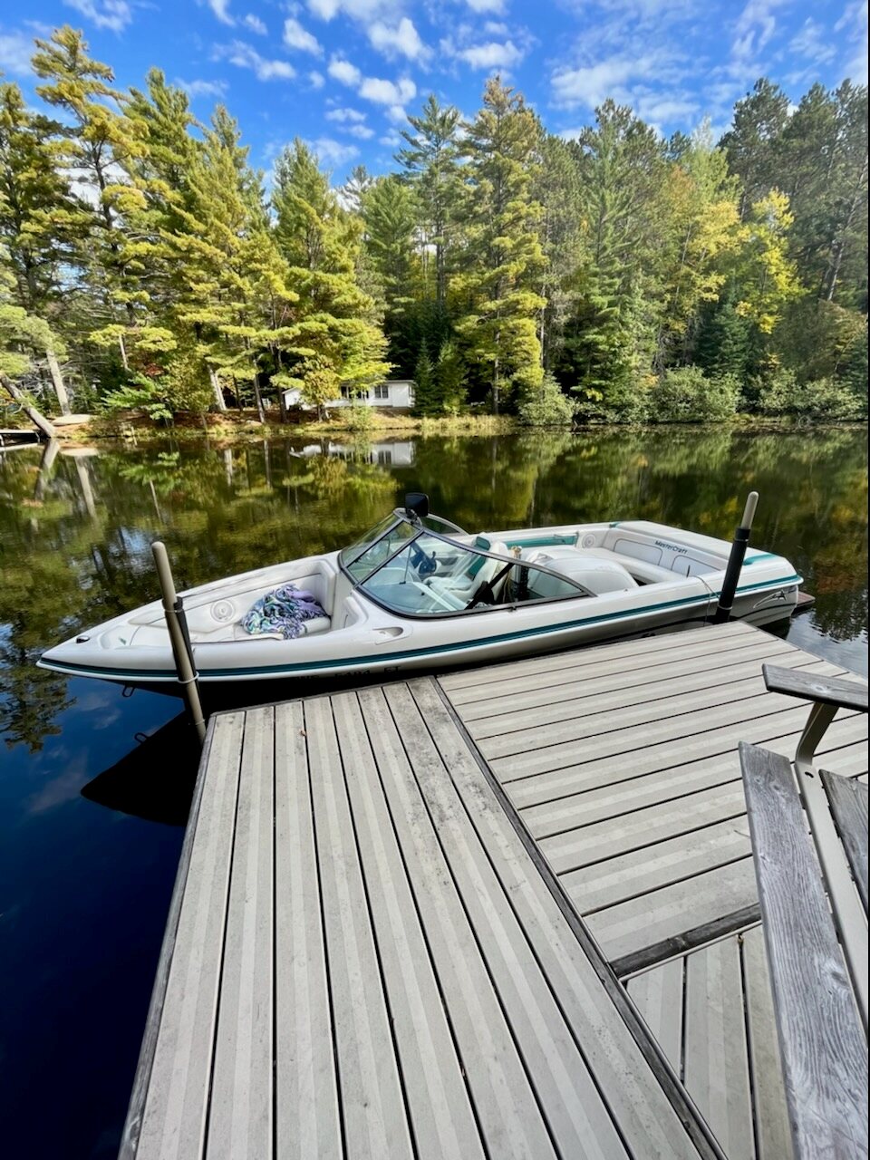 Private dock and boat on the river in fall