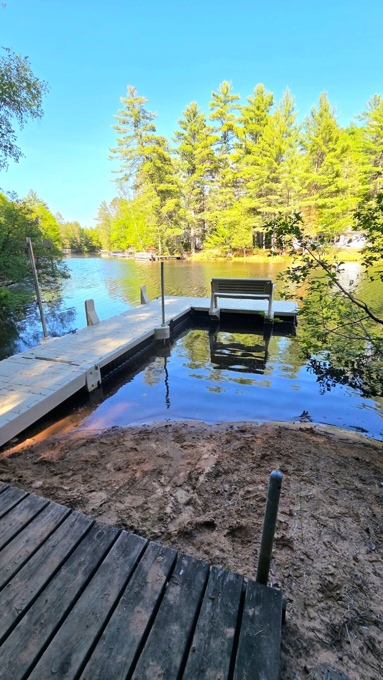Private dock, kayaks, and river in summer
